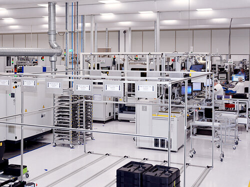 Moderne Produktionshalle mit Maschinen und Mitarbeitern
